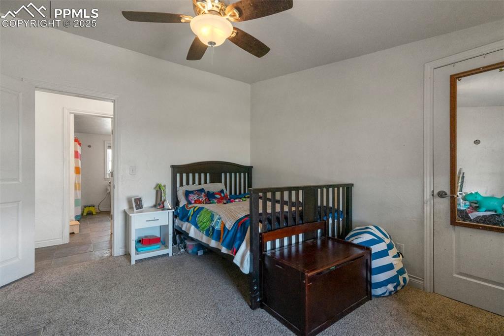 Image 30 of 50: Bedroom featuring a ceiling fan and carpet