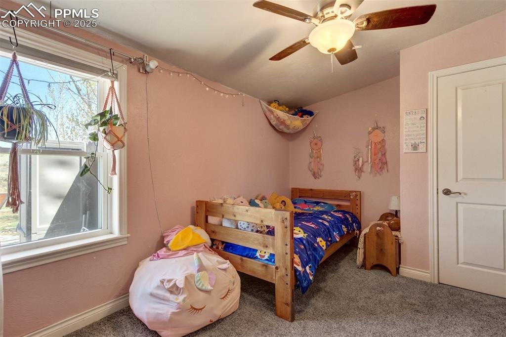 Image 31 of 50: Bedroom featuring baseboards, ceiling fan, and carpet