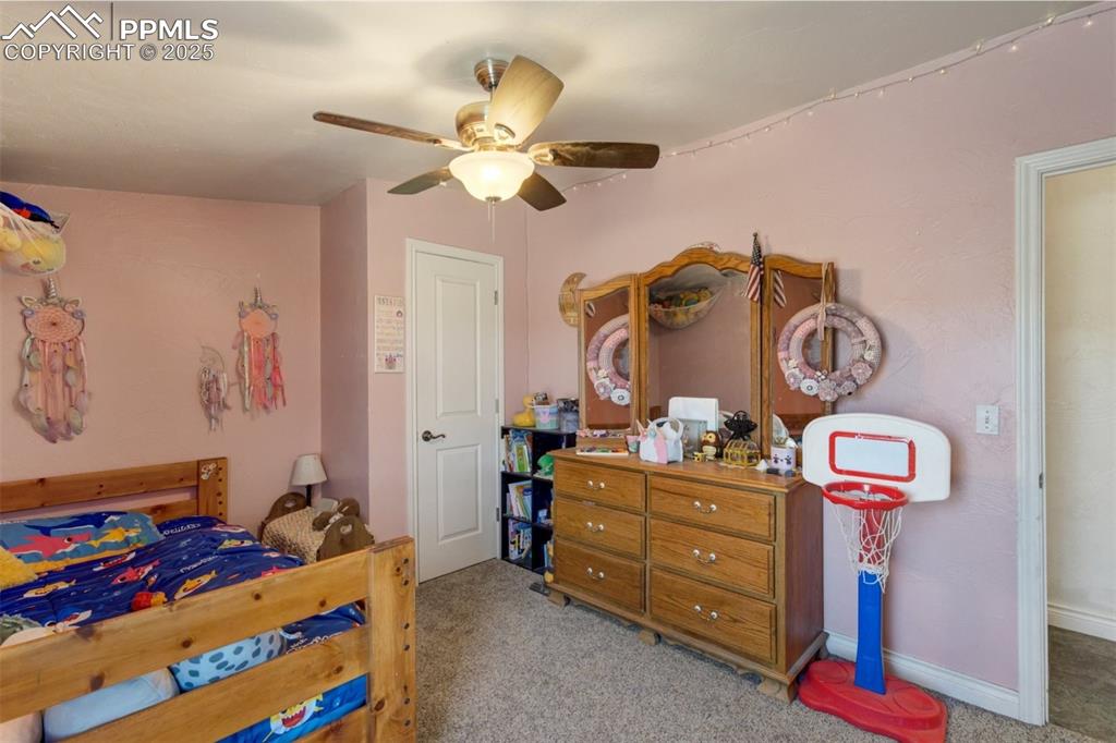 Image 32 of 50: Bedroom featuring baseboards, carpet, and ceiling fan