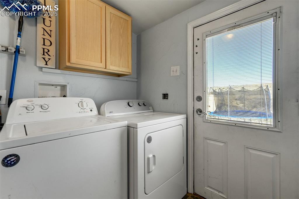 Image 35 of 50: Laundry room with cabinet space and washing machine and dryer