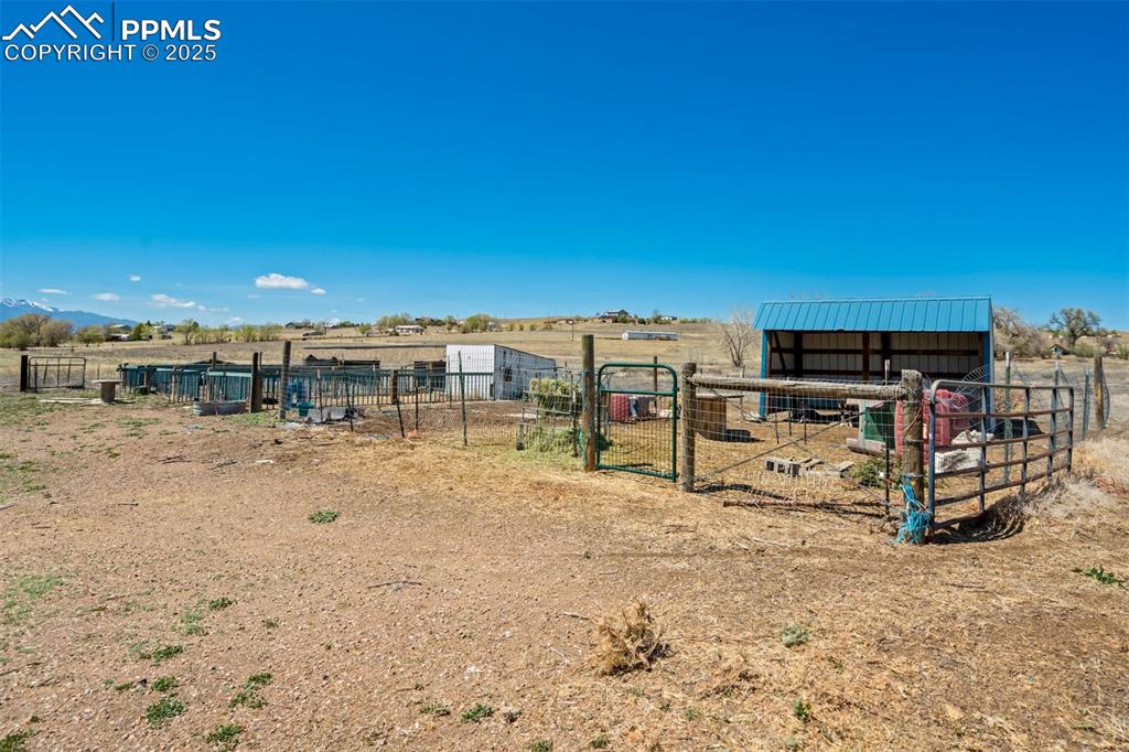 Image 40 of 50: View of yard featuring an outdoor structure, an exterior structure, and a r