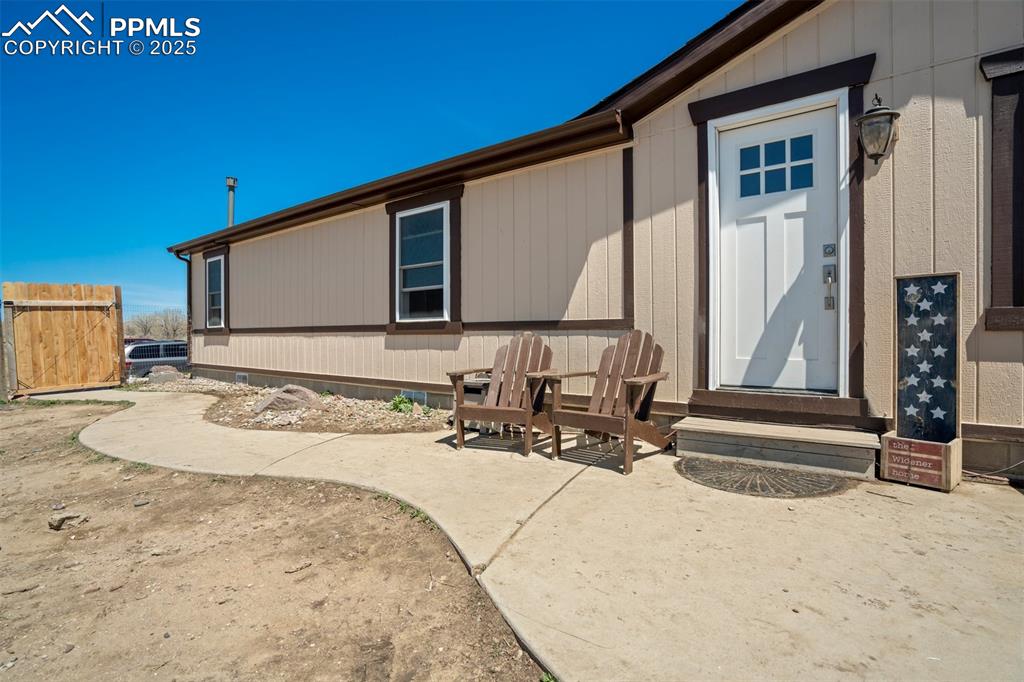 Image 5 of 50: Front of property featuring entry steps and a patio area