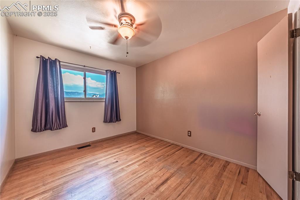 Image 20 of 31: Spare room featuring light wood-style floors and a ceiling fan