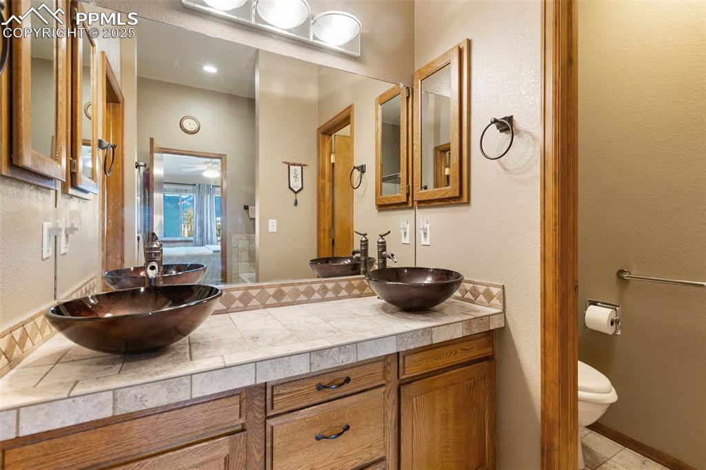 Image 18 of 43: Primary bathroom his and her sinks