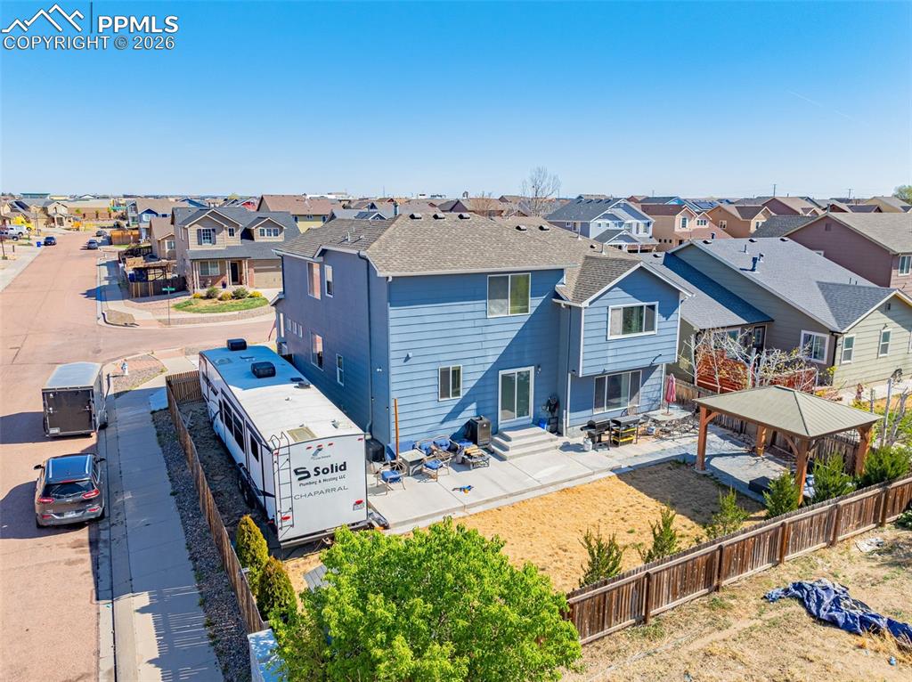 Image 26 of 40: Two-story property with light blue siding and a dark shingle roof