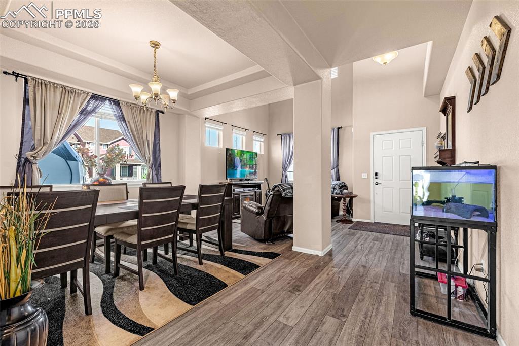 Image 4 of 40: Open-concept living space with wood-finish flooring extending throughout