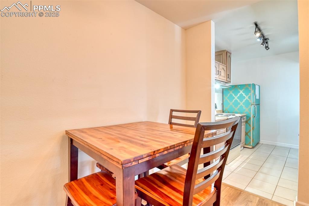 Image 10 of 31: Dining space featuring track lighting and light wood finished floors