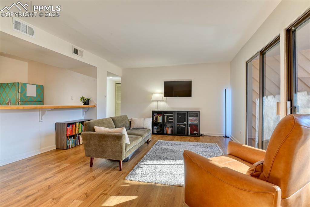 Image 15 of 31: Living room featuring wood finished floors