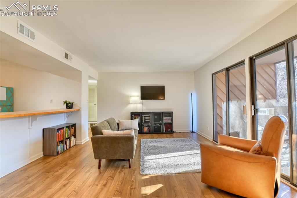 Image 16 of 31: Living room featuring light wood finished floors and baseboards