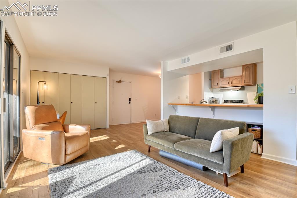 Image 17 of 31: Living room featuring light wood finished floors