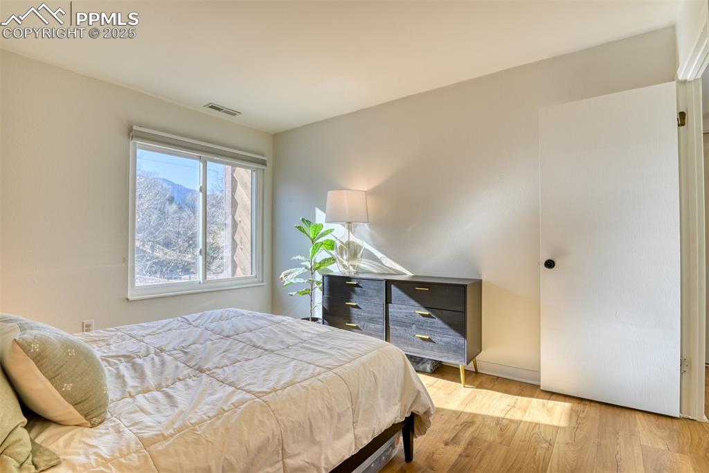 Image 22 of 31: Bedroom with wood finished floors