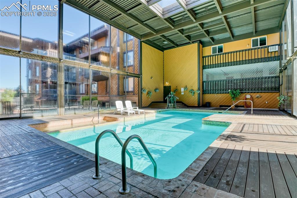 Image 28 of 31: Indoor pool featuring a wooden deck