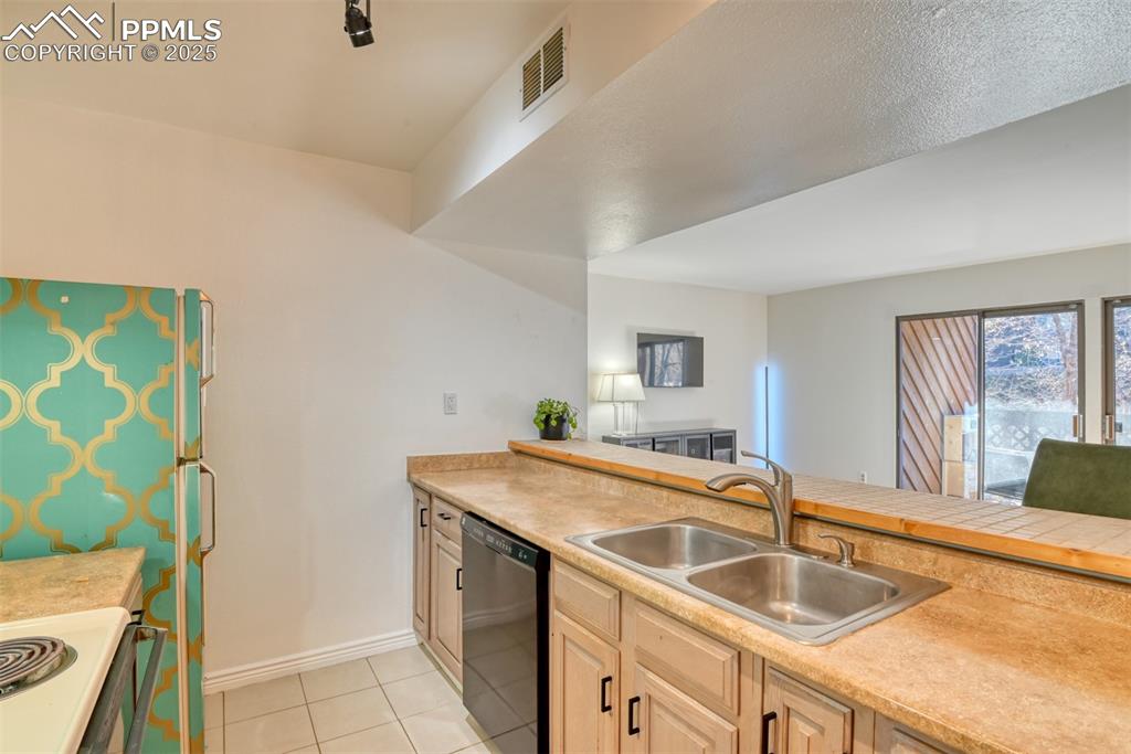 Image 6 of 31: Kitchen featuring light countertops, electric stove, dishwashing machine, a