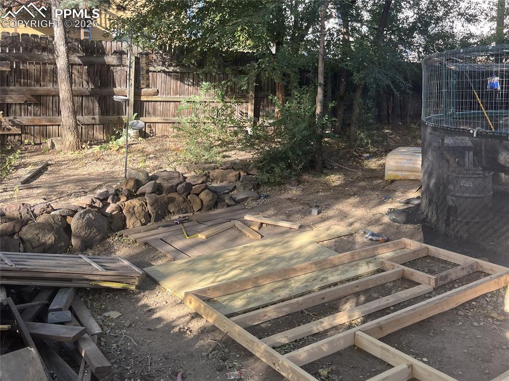 Image 15 of 20: West side of backyard.