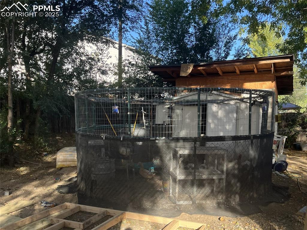 Image 16 of 20: Chicken coop, and two storage sheds beyond.