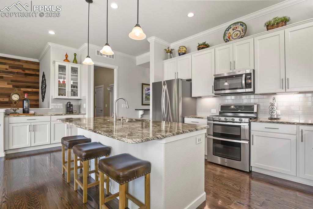 Image 7 of 50: Beautiful Kitchen with granite counters and glass cabinets