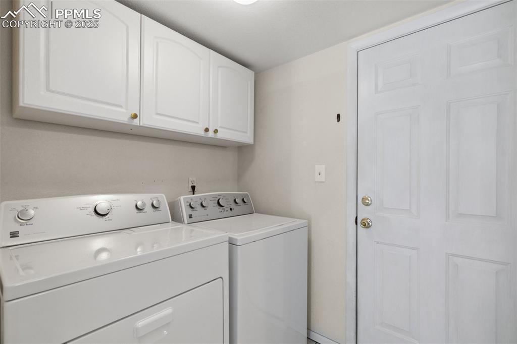 Image 15 of 29: Laundry room with washer and dryer and cabinet space