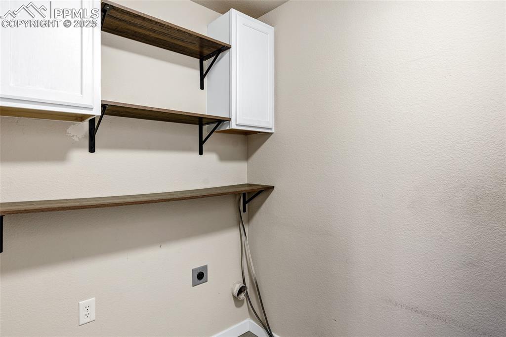 Image 10 of 22: Washroom featuring electric dryer hookup and baseboards