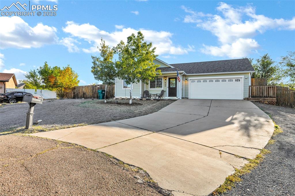 Image 2 of 22: Ranch-style house with driveway, an attached garage, and a shingled roof