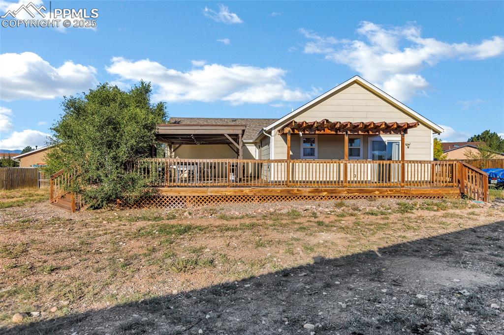 Image 20 of 22: Rear view of property featuring a deck
