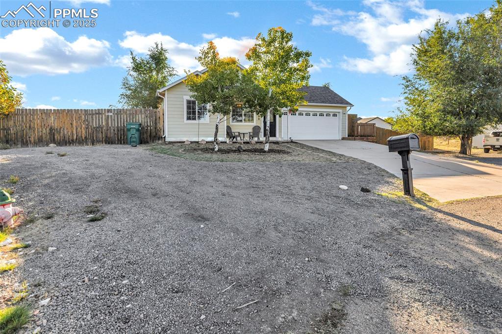 Image 3 of 22: View of front of property featuring driveway and a garage
