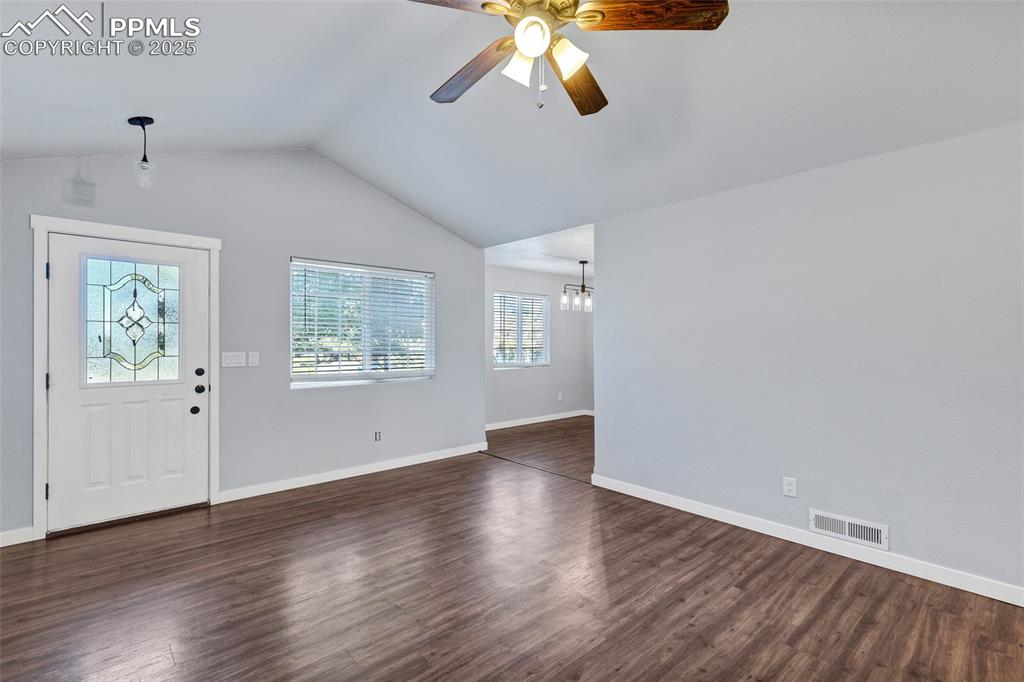Image 5 of 22: Entrance foyer featuring dark wood-style floors, vaulted ceiling, ceiling f