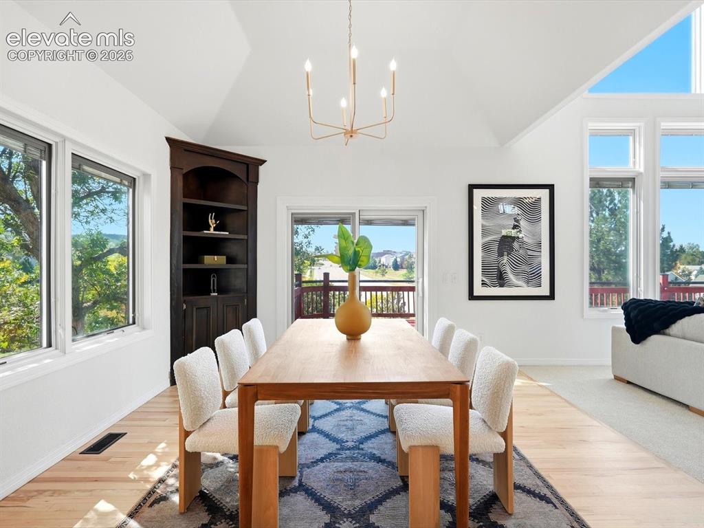 Image 13 of 48: Vaulted ceilings, built-in corner cabinetry, large picture windows, sliding