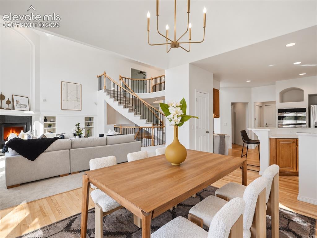 Image 14 of 48: Open-concept interior featuring vaulted ceilings, a central staircase with 
