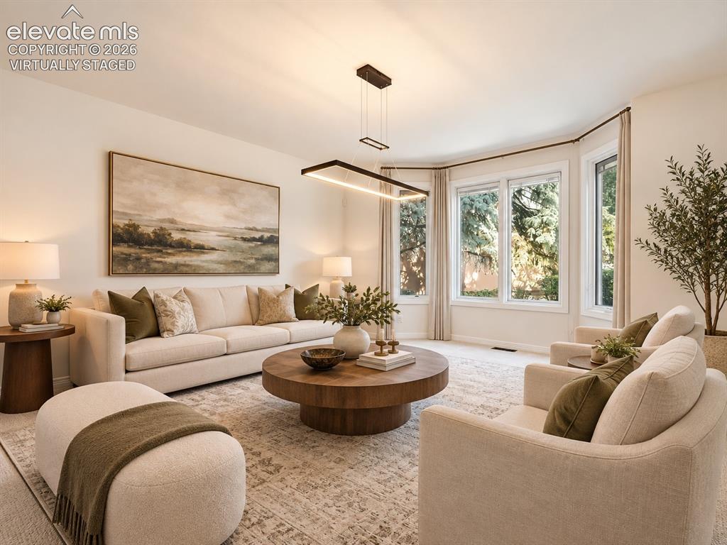 Image 18 of 48: Living area featuring a bay window, neutral wall paint, and a modern rectan