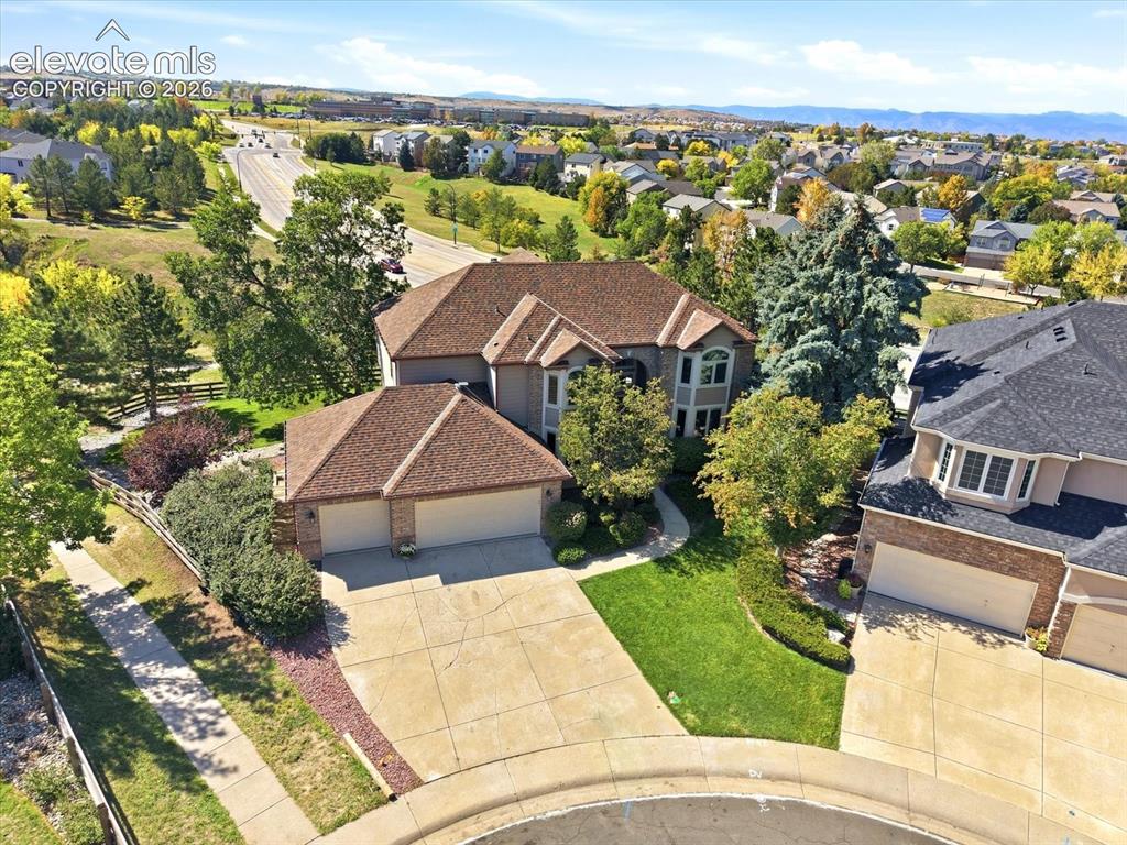 Image 2 of 48: Aerial perspective of a multi-gabled residence featuring a multi-car garage