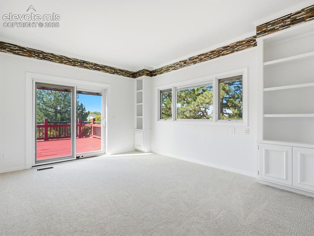 Image 22 of 48: Interior space featuring built-in floor-to-ceiling shelving, stone-tiled cr