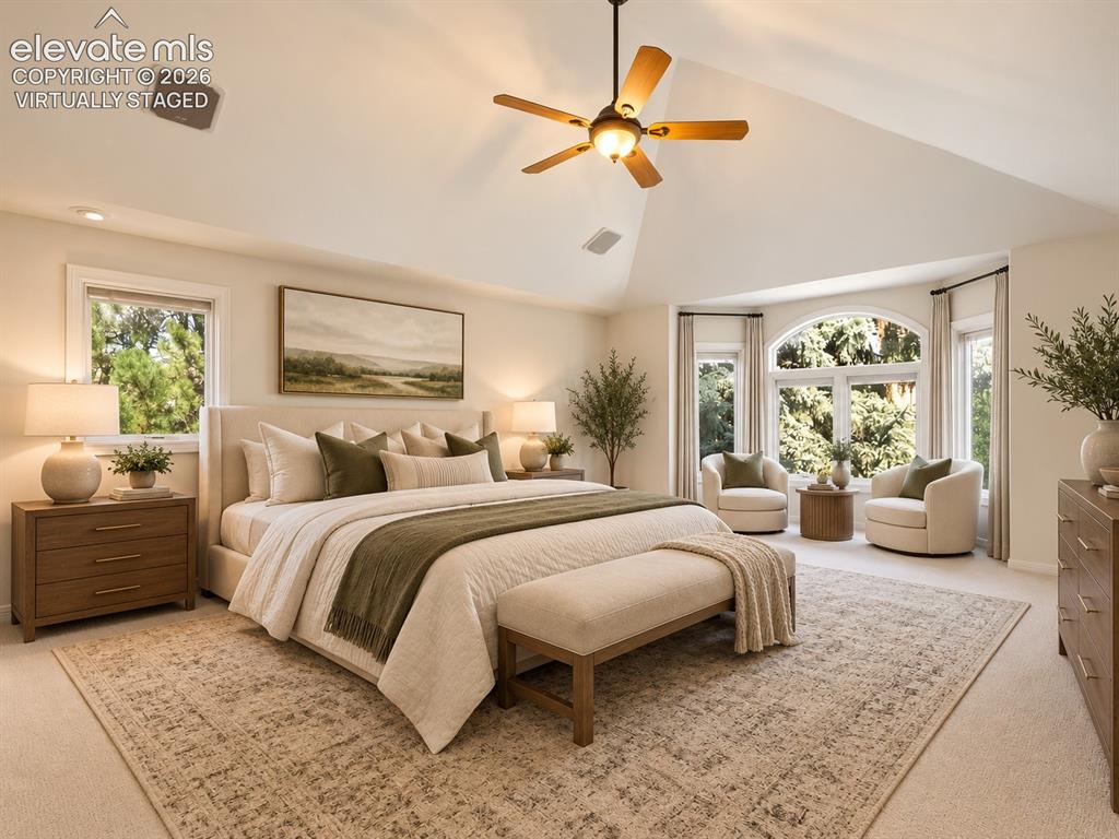 Image 26 of 48: Vaulted ceiling featuring a central lighted ceiling fan, expansive windows 