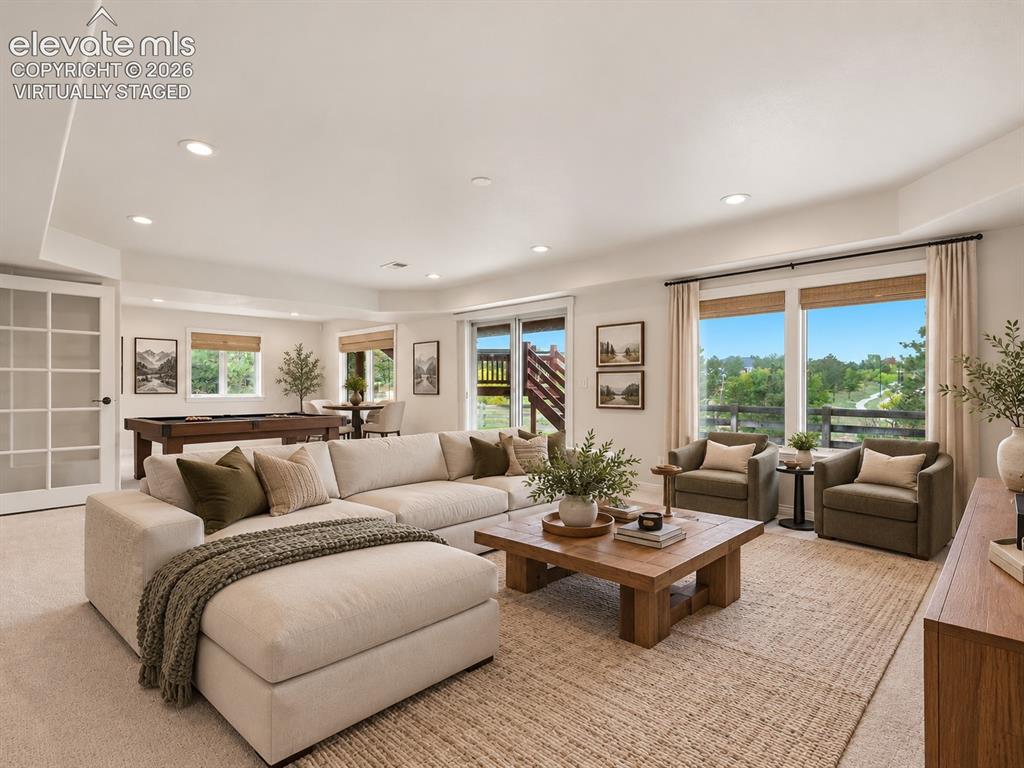 Image 38 of 48: Neutral-toned carpeted flooring, recessed lighting, expansive glass sliding