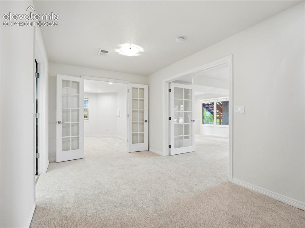 Image 40 of 48: Neutral-toned wall-to-wall carpeting and crisp white interior paint, highli