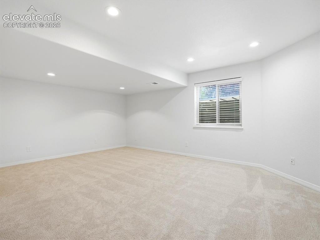 Image 41 of 48: Neutral interior space featuring wall-to-wall carpeting, recessed ceiling l