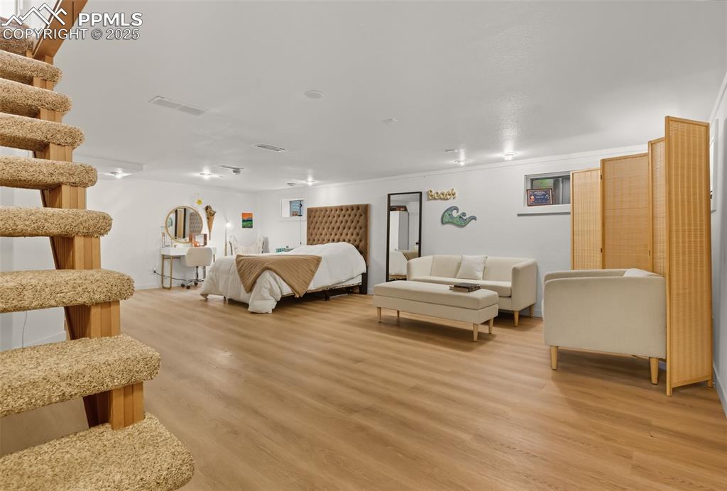 Image 27 of 49: Finished basement is used as a bedroom