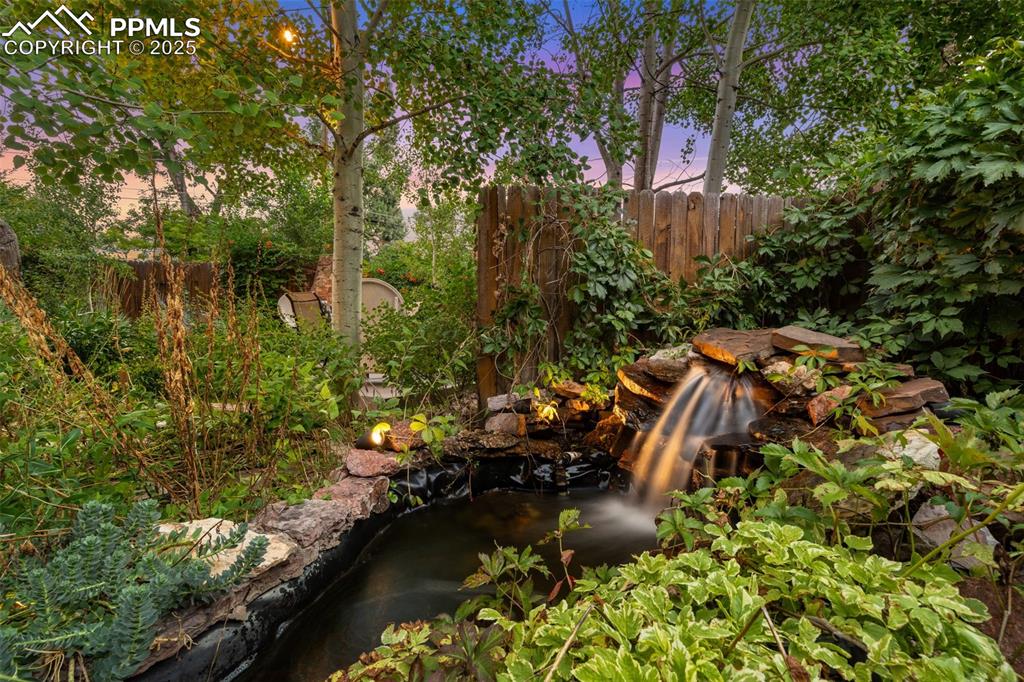Image 5 of 49: Year-round waterfall and pond in the backyard