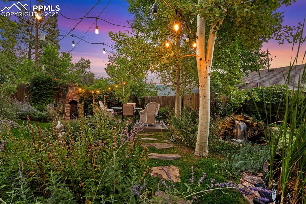 Image 6 of 49: Oasis backyard with aspen and apple trees