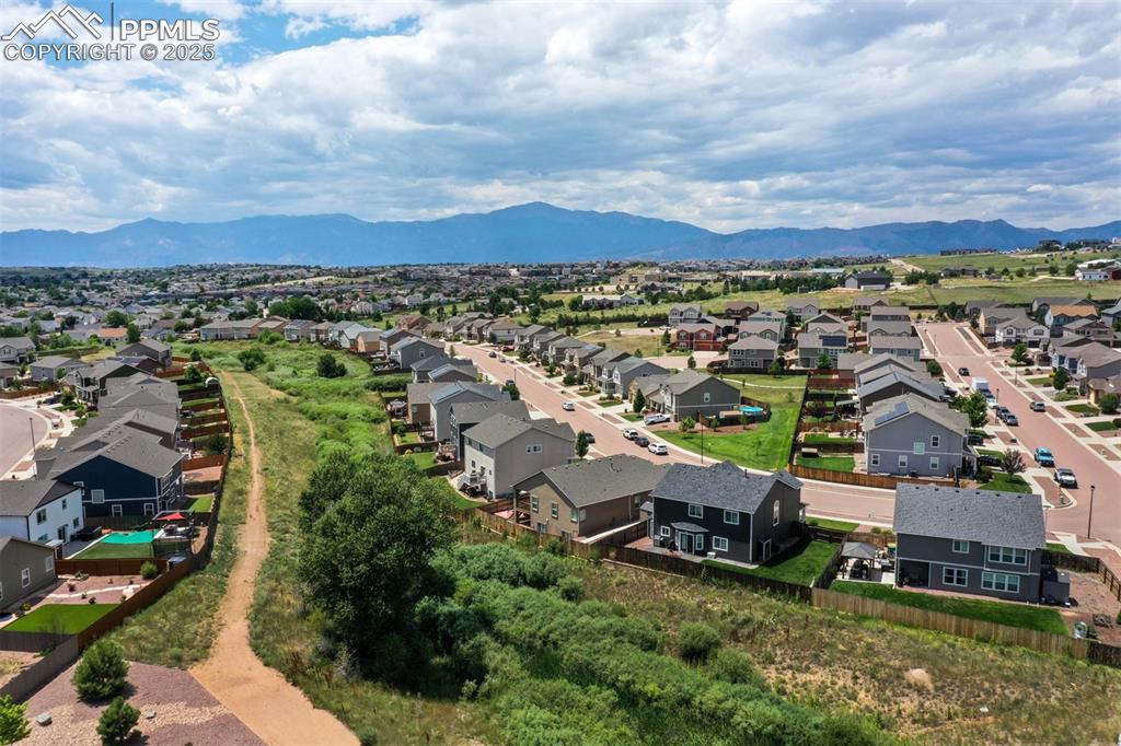 Image 45 of 46: Aerial view of residential area with a mountain backdrop