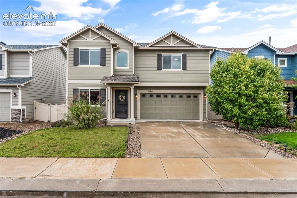 Image 1 of 42: Two-story exterior with siding, attached garage, and arched window