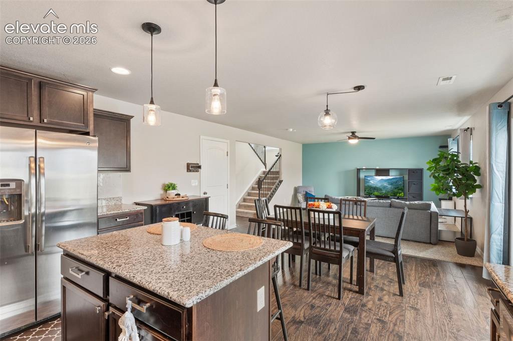 Image 19 of 42: Kitchen island with a granite countertop, wood-finish flooring, recessed li