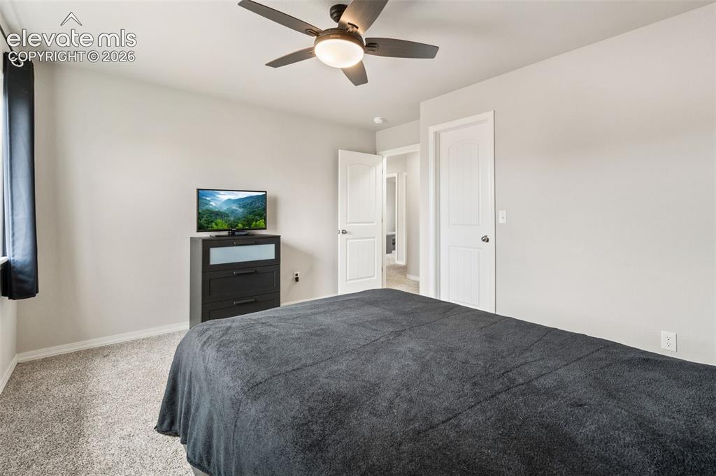 Image 33 of 42: Carpeted flooring, ceiling fan with integrated lighting, and white paneled 