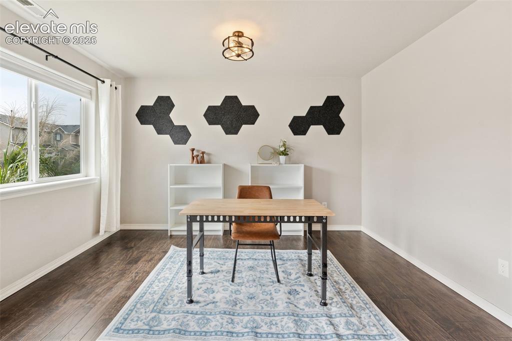 Image 6 of 42: Large window with white trim, wood-finish flooring, and a flush mount ceili