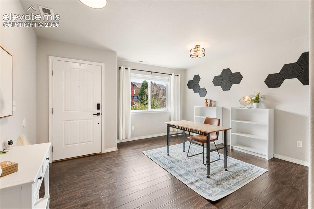 Image 7 of 42: Entryway with wood-finish flooring, a white paneled door, and a multi-pane