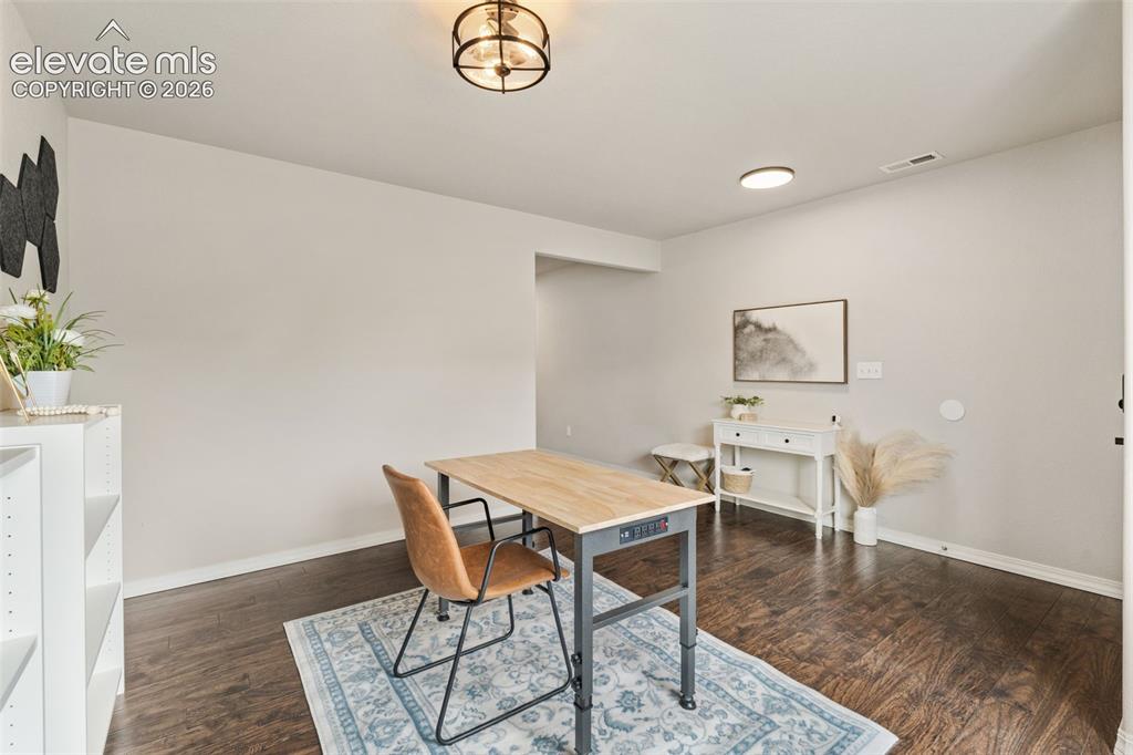 Image 8 of 42: Wood-finish flooring, recessed lighting, and a semi-flush mount ceiling fix