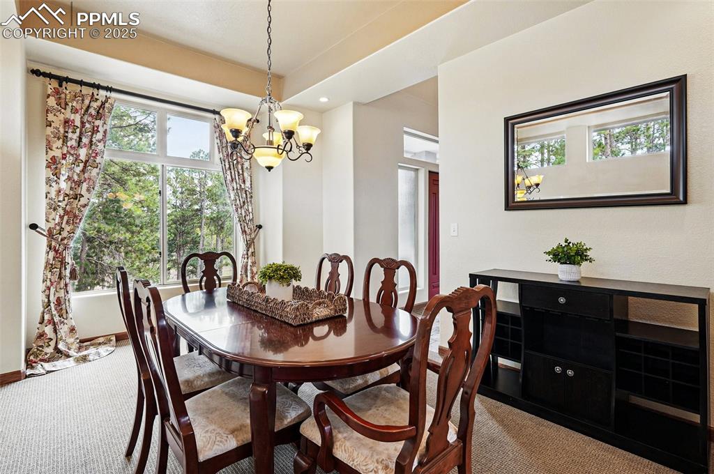 Image 12 of 38: Dining space with a chandelier, carpet floors, and recessed lighting