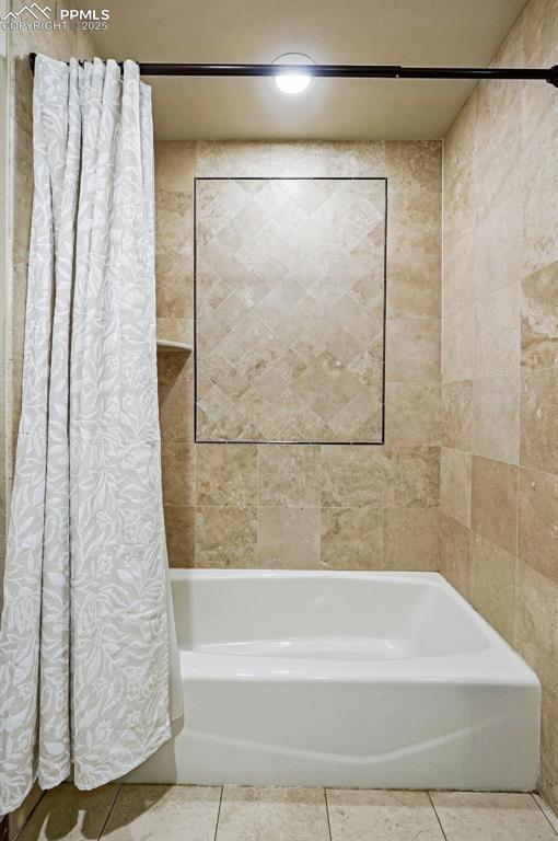 Image 18 of 38: Full bath with tile patterned flooring and shower / tub combo