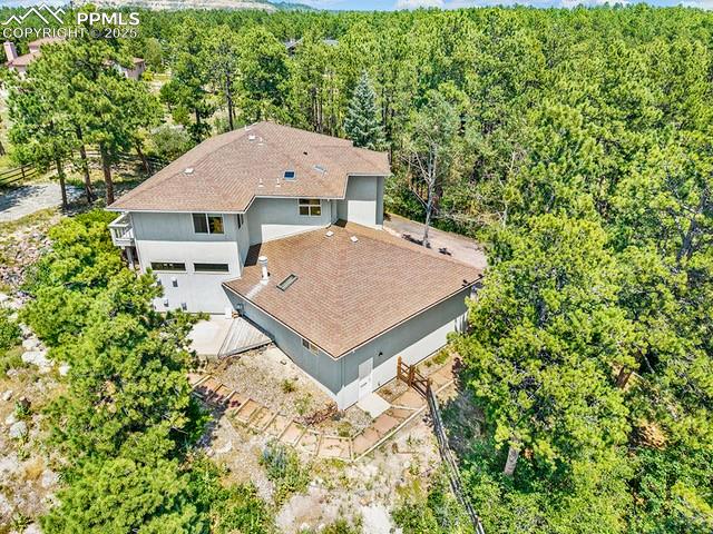 Image 41 of 42: Aerial view of property and surrounding area with a forest