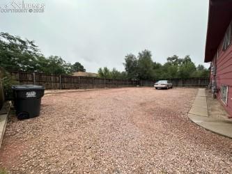 Image 4 of 6: View of fenced backyard