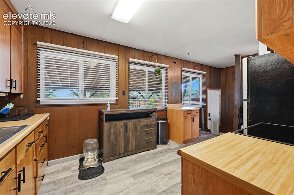 Image 13 of 30: Kitchen and Back Door to Covered Deck